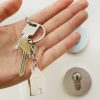 Hand holding keys representing closing on a real estate transaction