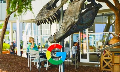 Dino holding Google logo on campus.