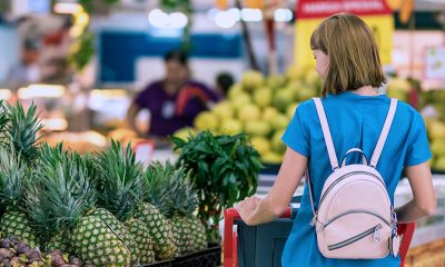 Woman grocery shopping, showing economy changes