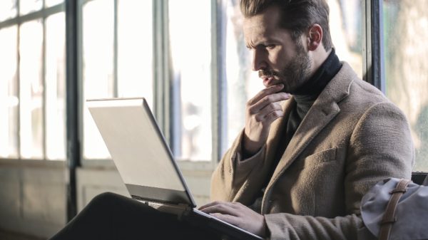 Person looking confused at their laptop showing customer service mistake