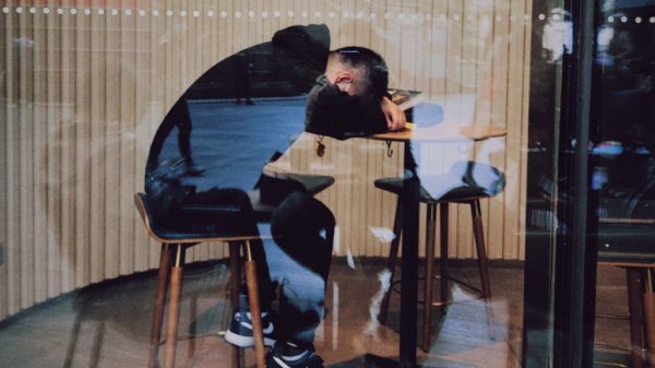 burnout and exhausted person sleeping on table at cafe