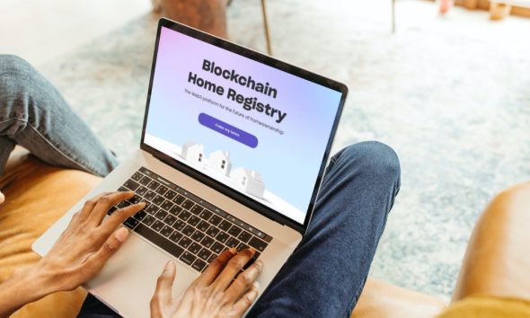 Man using laptop to look at Blockchain Home Registry