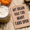 book that says 'my brain has too many tabs open' representing lack of ability to concentrate due to technology.