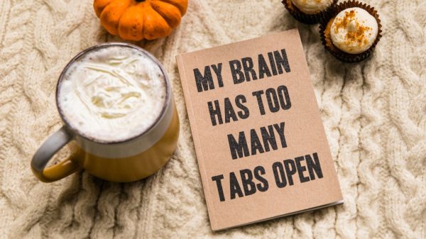 book that says 'my brain has too many tabs open' representing lack of ability to concentrate due to technology.