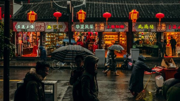 people at a outdoor market in china representing recession