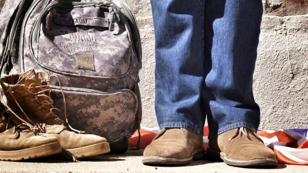 veteran with boots and backpack representing incoming inflation when looking for an apartment that tom hanks is apart of
