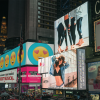 A view of Times Square in New York featuring many glowing billboards and visual advertisements.