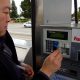Man inserting card to buy cheap gas at a GasBuddy recommended location.