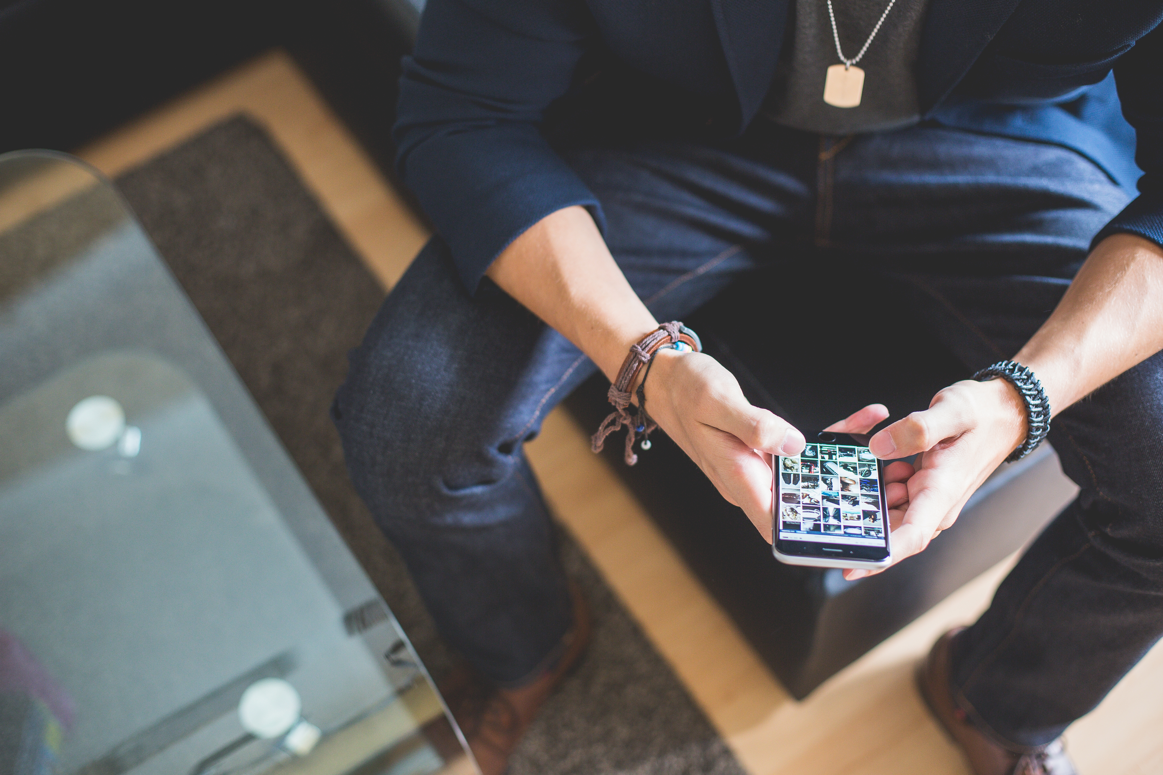 Man browsing on phone representing male career hacks.