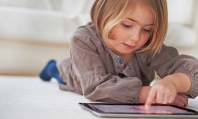 Child on electronic device- iOS 15 beta that will allow blur nude photos should protect children.