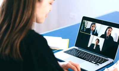 Woman networking through Zoom video call with two other women.