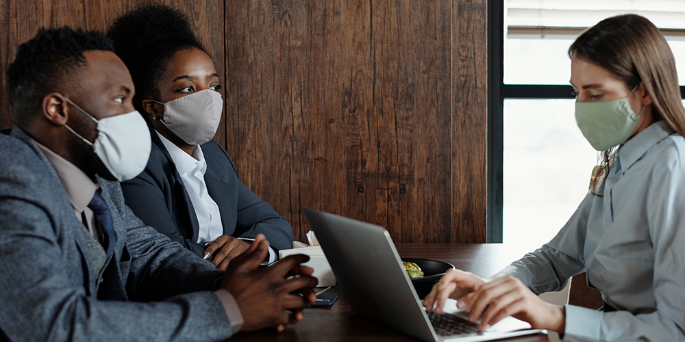 Masked people in meeting, but employers may find it hard to keep safe