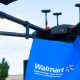 Walmart drones carrying a blue Walmart bag, being tested for grocery delivery.