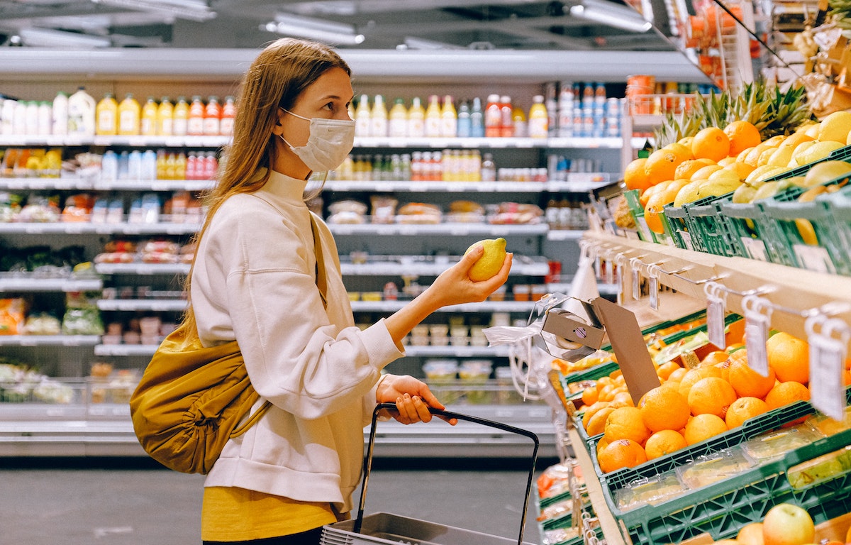 woman shopping at grocery store with mask on