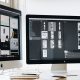Website design open on dual monitors for an entrepreneur.