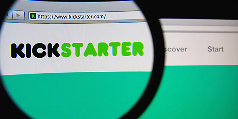Magnifying glass over Kickstarter URL and site, a crowdfunding website.