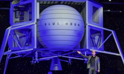 Jeff Bezos standing in front of very large Blue Moon spacecraft.