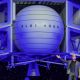 Jeff Bezos standing in front of very large Blue Moon spacecraft.