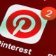 Pinterest icon on phone with 2 notifications, indicating new code of conduct.