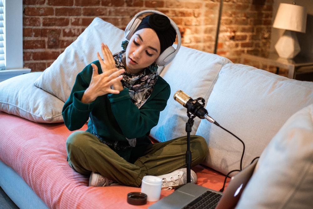 Woman in hijab showing lotion on a video call.