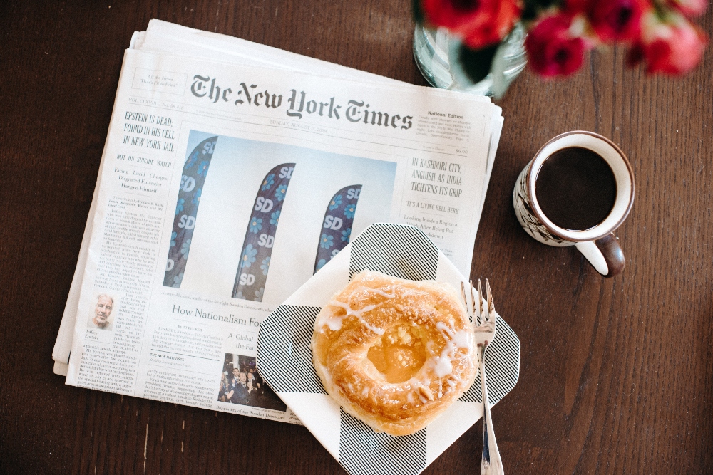 he New York Times paper with coffee and a donut representing Twitter memo.