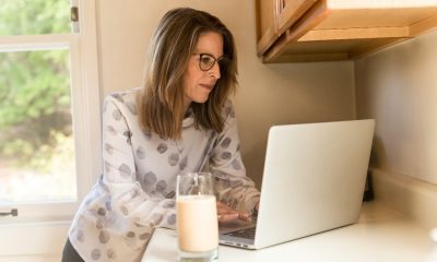 Lady resting on counter on laptop, representing age discrimination