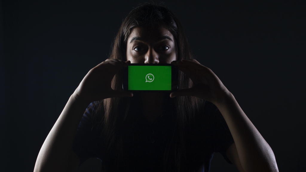 Woman holding Whatsapp app open on iphone