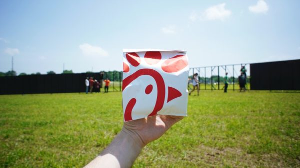 Person holding Chick-Fil-A sandwich bag representing 3-day workweek trial