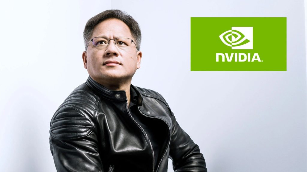 A picture of Jensen Huang, founder and CEO of NVidia, posing with hands crossed and looking off screen thoughtfully next to a logo of NVidia.