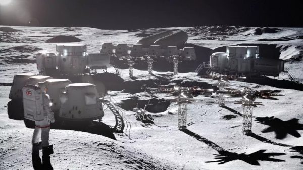 An astronaut stands on the moon besides white lunar base buildings built by Rolls-Royce