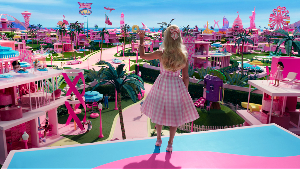 Barbie, dressed in a pink gingham dress, overlooks Barbieland, a vibrantly pink town with various buildings, a treehouse, and more. Change management remains a core of the film.