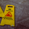 Two yellow caution wet floor signs on a cement floor representing workers' compensation cases.