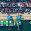 A bird's eye view of a ship docking at a port where the supply chain can be managed.